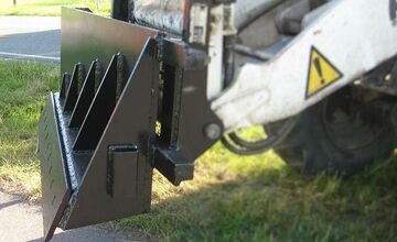 Custom-made plow for removing overgrowth from the roadside, such as grass, weeds and scrub